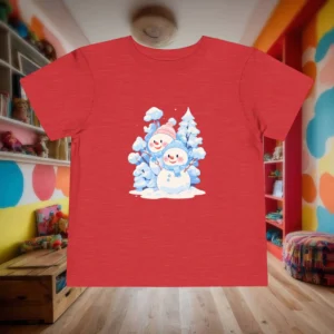 Flat red toddler t-shirt with two smiling snowmen and snowy pine trees graphic