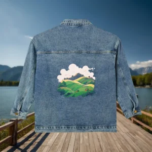 Flat view of denim jacket with green rolling hills and cloudy sky artwork on the back.