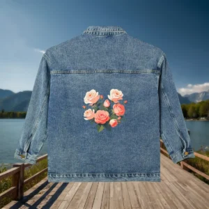 Flat view of denim jacket with a bouquet of pink roses printed on the back.