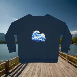 Flat lay of navy sweatshirt with ocean waves print, displayed on a wooden boardwalk by the lake