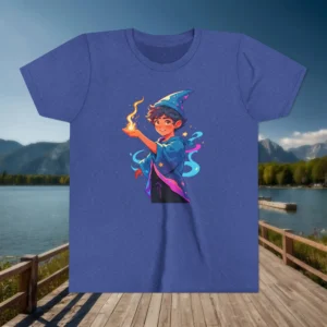 Heather blue youth t-shirt with a colorful cartoon sorcerer casting a fire spell, displayed outdoors near a lake