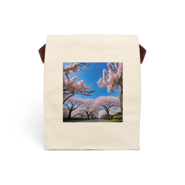 Canvas lunch bag with strap featuring a scenic view of cherry blossom trees in full bloom under a bright blue sky