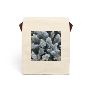 Canvas lunch bag with strap featuring a design of close-up frosted evergreen branches