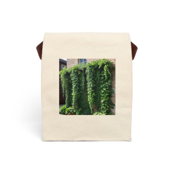 Canvas lunch bag with strap featuring a lush green ivy cascading down a brick wall design