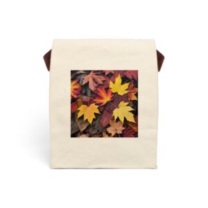 Canvas lunch bag with strap featuring a design of autumn leaves in shades of yellow, orange, and brown