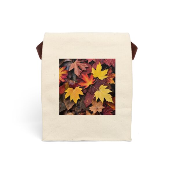 Canvas lunch bag with strap featuring a design of autumn leaves in shades of yellow, orange, and brown