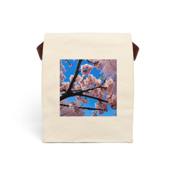 Canvas lunch bag with strap featuring a cherry blossom branch with pink flowers against a bright blue sky