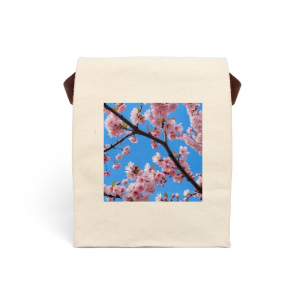 Canvas lunch bag with strap featuring cherry blossom branches with pink flowers against a bright blue sky