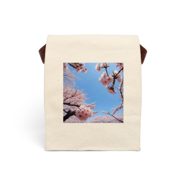 Canvas lunch bag with strap featuring a scenic view of cherry blossom trees in full bloom under a bright blue sky