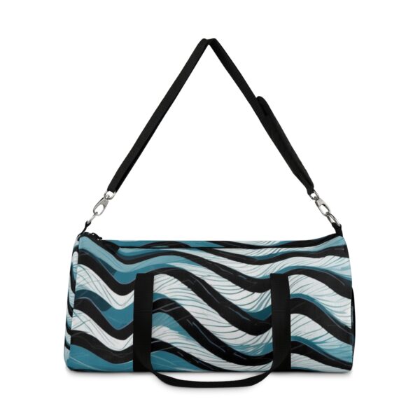 Duffel bag with black, white, and blue wave pattern and adjustable shoulder strap