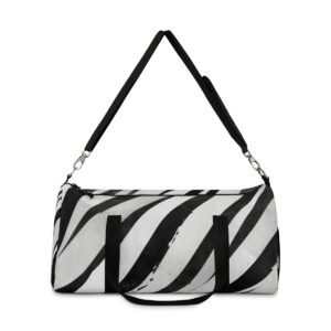 Duffel bag with bold black and white diagonal stripes and adjustable shoulder strap