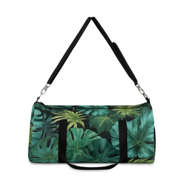 Duffel bag with layered green tropical leaf pattern and detachable shoulder strap