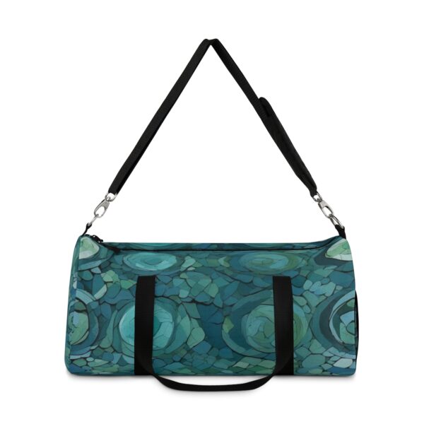 Duffel bag with abstract overlapping circular patterns and adjustable shoulder strap