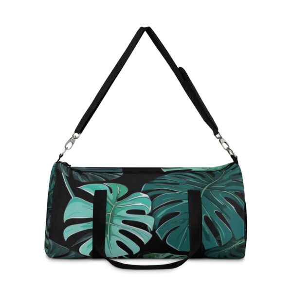 Duffel bag with dark Monstera leaf design and detachable shoulder strap