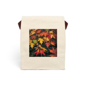 Canvas lunch bag with strap featuring a design of autumn leaves in warm shades of red, orange, and yellow