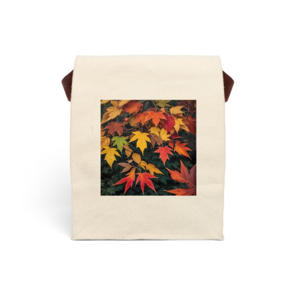 Canvas lunch bag with strap featuring a design of autumn leaves in warm shades of red, orange, and yellow