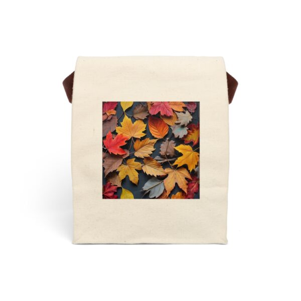 Canvas lunch bag with strap featuring a design of autumn leaves in vibrant shades of red, yellow, orange, and brown