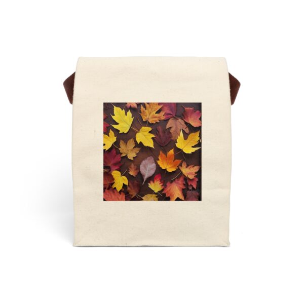 Canvas lunch bag with strap featuring a design of autumn leaves in warm tones of yellow, orange, and red