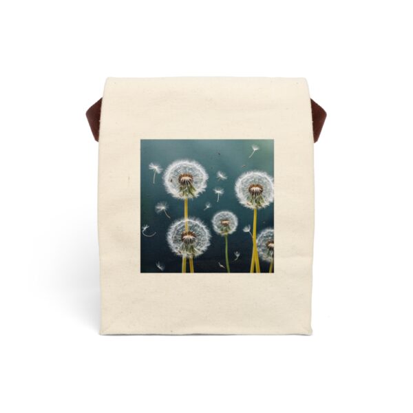 Canvas lunch bag with strap featuring a dandelion seed heads with seeds drifting in the wind design