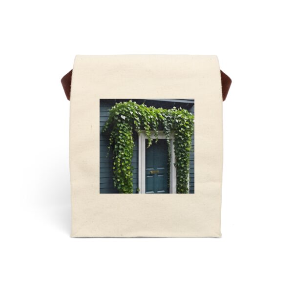 Canvas lunch bag with strap featuring a cascading ivy around a blue doorway design