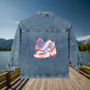 Flat view of a denim jacket with colorful graphic of two high-top sneakers.