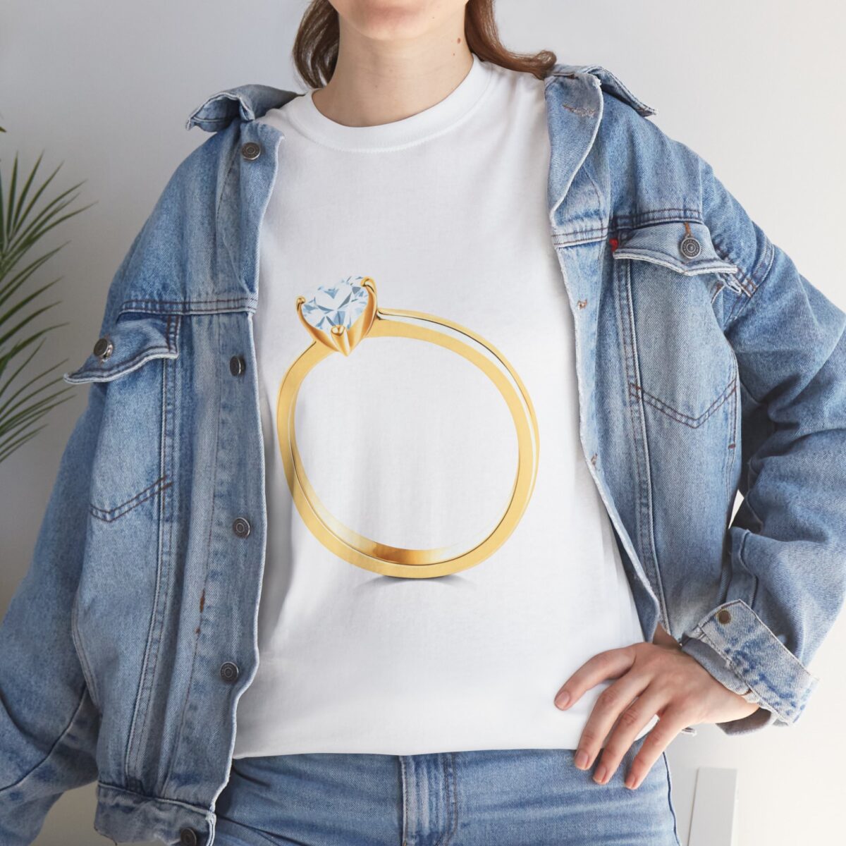 Woman wearing a Bride T-Shirt with a gold engagement ring design, styled with a denim jacket.