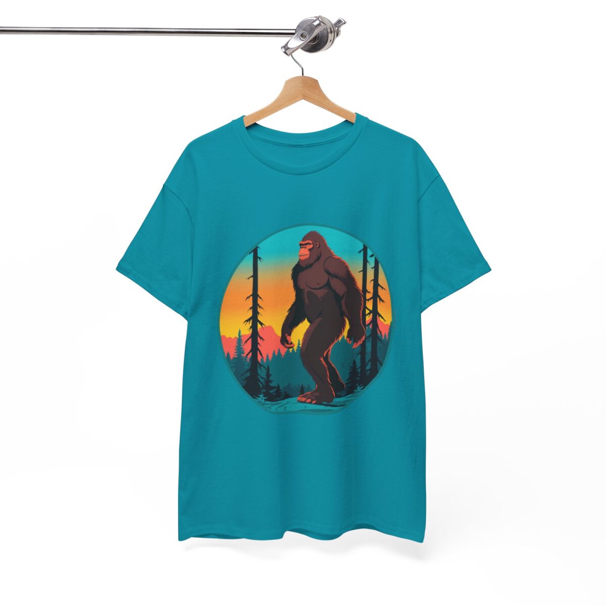 Bigfoot T Shirt with forest sunset design on a hanger