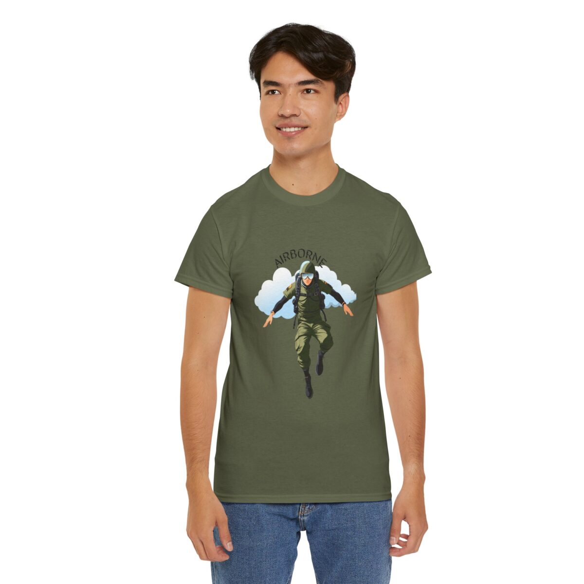 A man wearing an Airborne T Shirt​ with a bold paratrooper design, standing confidently.