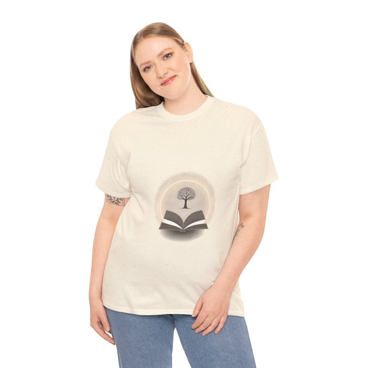 Woman wearing a beige T-shirt with a tree and open book design, symbolizing growth and reading.