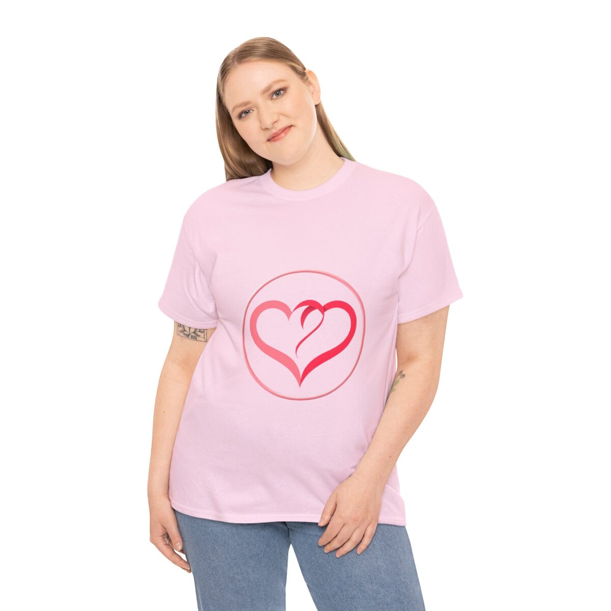 Woman wearing a pink Girlfriend T Shirt with a heart motif, casual and trendy design.