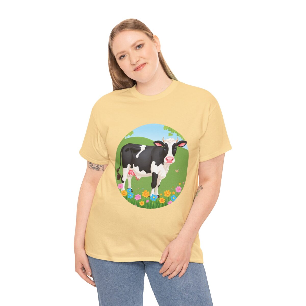 Woman wearing a Cow T-Shirt with a countryside illustration