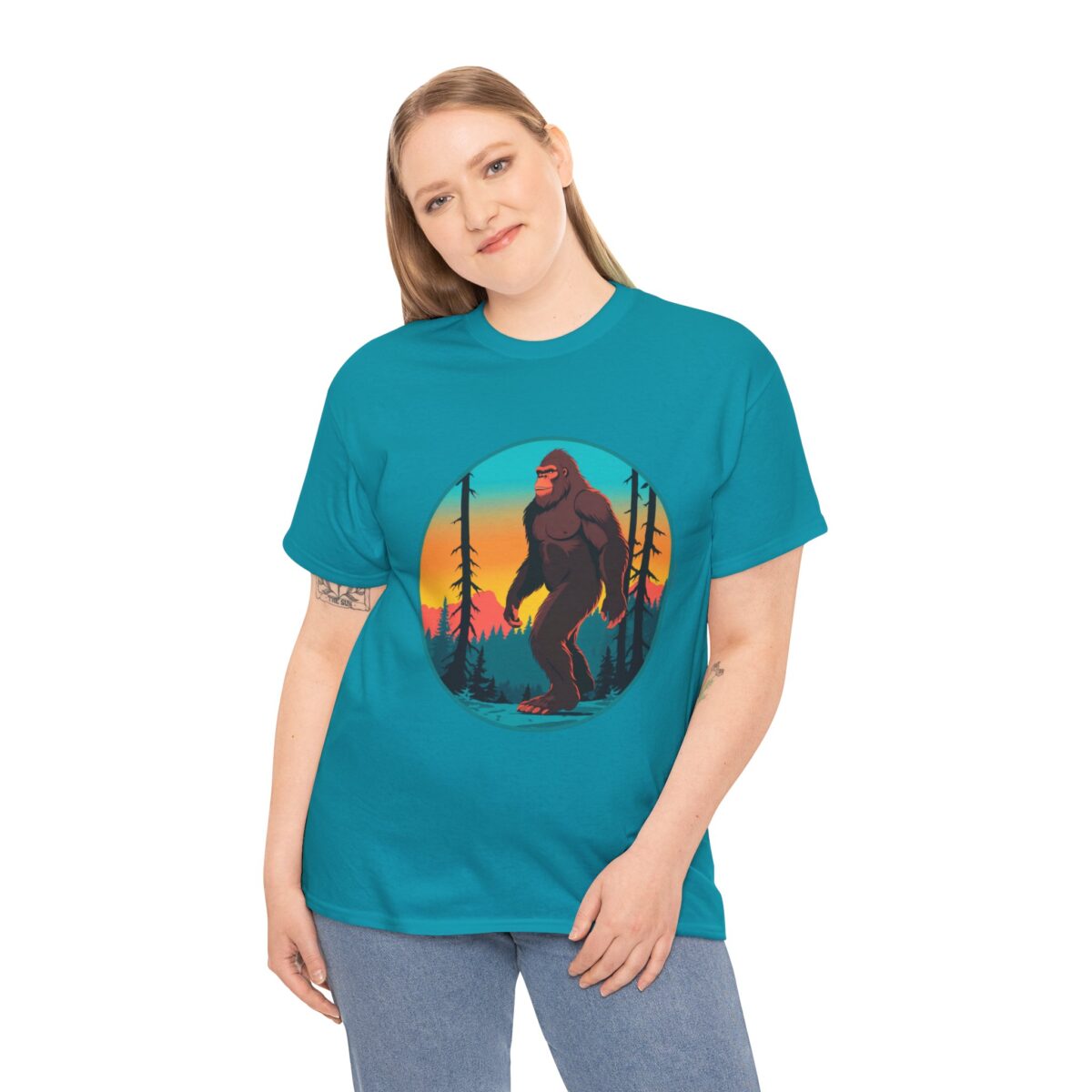 Woman wearing a Bigfoot T Shirt with a vibrant forest sunset design