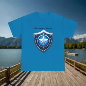 Flat lay of blue t-shirt with a silver shield and star graphic and "Defenders of Justice" text