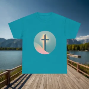 Teal t-shirt with Christian cross design laid flat