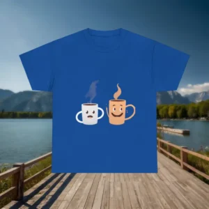 Blue t-shirt with smiling and frowning cartoon mugs laid flat