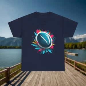 Dark t-shirt with a rugby ball surrounded by multicolored flower petals displayed on a wooden dock with lake and mountain background
