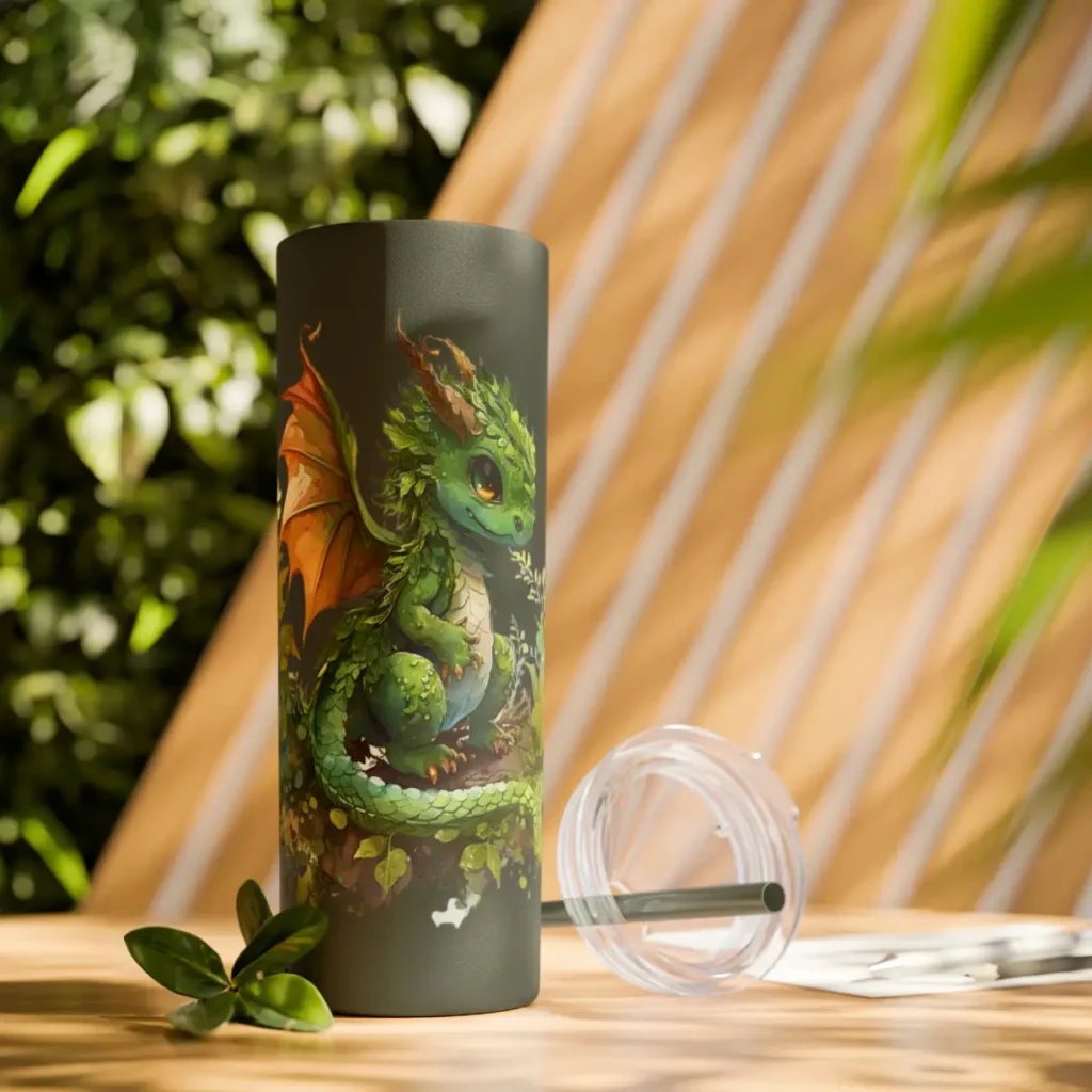 skinny tumbler with dragon design and straw on table