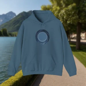 Blue acid wash hoodie with abstract circular design, flat display by the lake