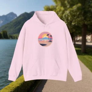 Light pink hoodie with a California beach sunset design, displayed outdoors near a mountain lake.
