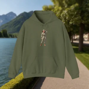 Olive green hoodie with a printed female soldier in camouflage, shown outdoors by a mountain lake.