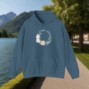 Flat view of a blue hoodie with a pastel flower wreath in the center
