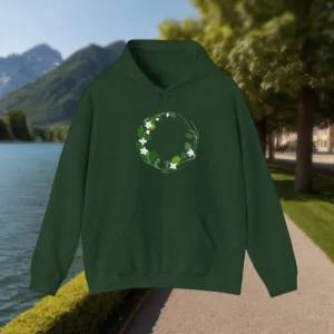 Flat-lay of a dark green hoodie with a white flower and leaf wreath design