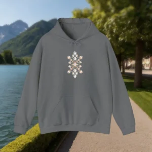Grey hoodie with central rhinestone-style pattern laid flat outdoors