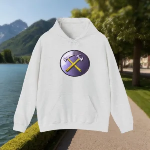 Flat-lay of light grey hoodie with yellow crossed hammers on a purple badge