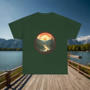 Forest green t-shirt with mountain valley and sunset landscape graphic placed on wooden dock by the lake